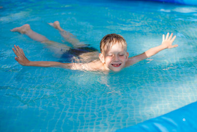 Boy swimming in pool