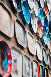 Low angle view of metallic plates mounted on brick wall