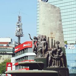 Low angle view of statue in front of building