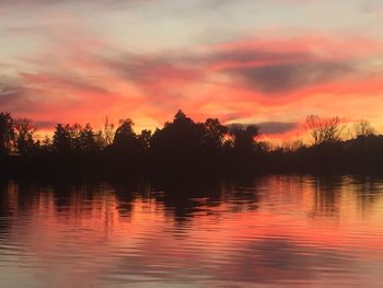 Scenic view of lake against romantic sky at sunset