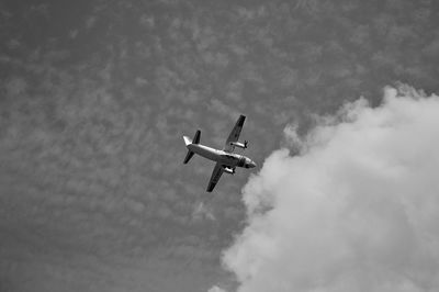 Low angle view of airplane flying in sky