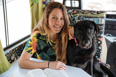 Woman traveling with dog in camper van