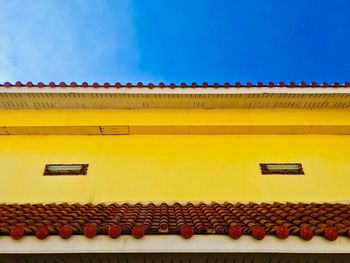 Low angle view of yellow roof against sky