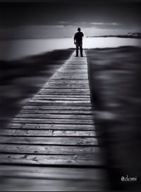 Full length of woman walking on boardwalk