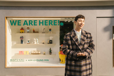 Full length of man standing in store