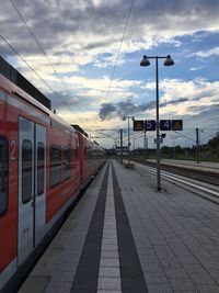 Train at germersheim station against cloudy sky