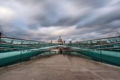 Diminishing view of london millennium footbridge against cloudy sky