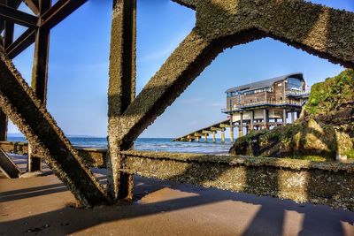 Low angle view of built structure lifeboat station against blue sky