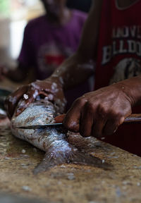 Man preparing fish on table
