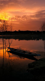 Scenic view of lake against romantic sky at sunset