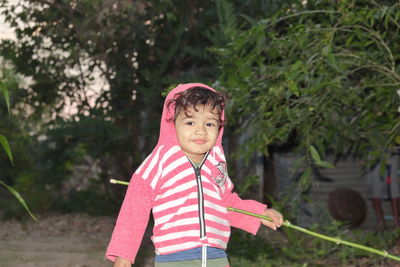 Portrait of cute boy standing outdoors