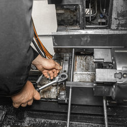 Low angle view of man working on machine