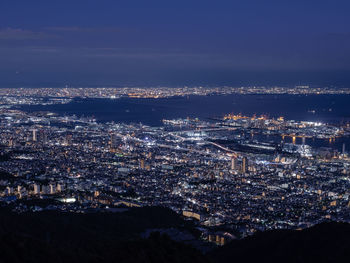 Aerial view of illuminated cityscape against sky at night