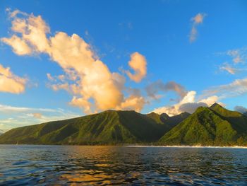 Scenic view of lake by mountains against sky