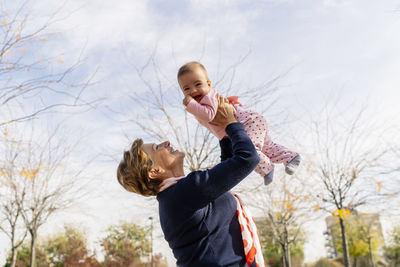 Grandmother playing with her granddaughter in the park