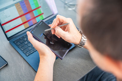 Midsection of man using laptop