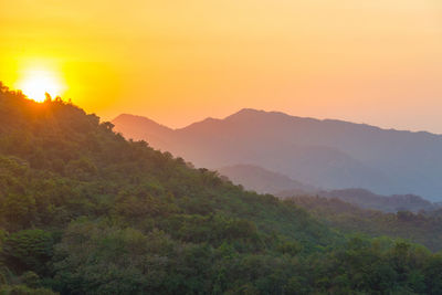 Scenic view of mountain range against clear sky during sunset
