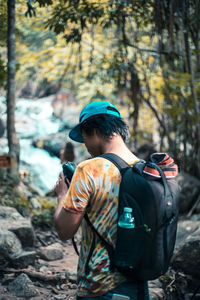 Rear view of man standing in forest