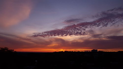 Scenic view of silhouette landscape against romantic sky at sunset