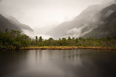 Scenic view of lake and mountains against sky