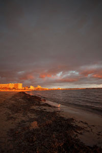 Scenic view of beach against sky during sunset