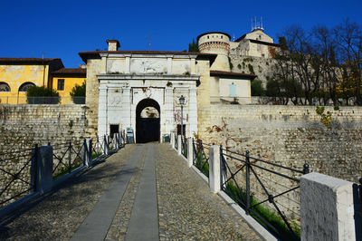 Walkway against clear sky