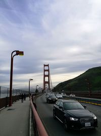 Cars on road in city against sky