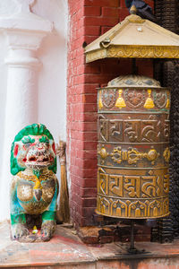 Buddha statue against wall of building