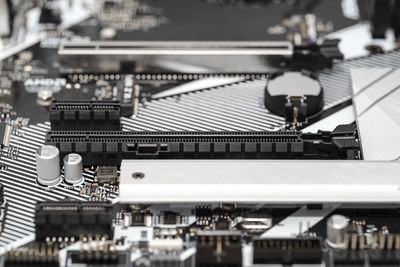 A macro shot of a pci express 3.0 x16 and x1 connector on a modern desktop motherboard.