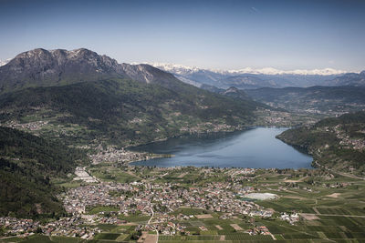 High angle view of townscape by mountains against sky