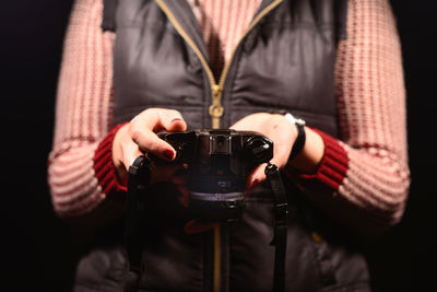 Close-up of a woman holding camera