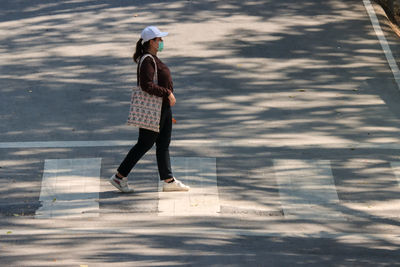 Full length side view of woman walking on water