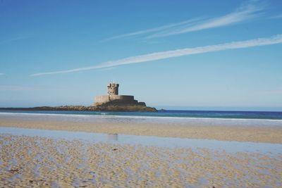 Building on beach against sky