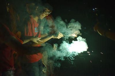 Friends with sparklers at night