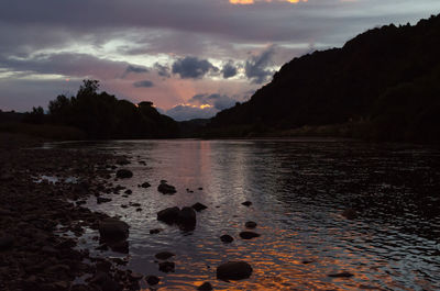 Scenic view of lake against sky during sunset