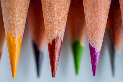 Close-up of multi colored pencils over white background