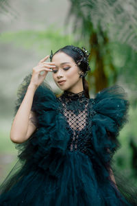 Portrait of young woman in traditional clothing standing outdoors