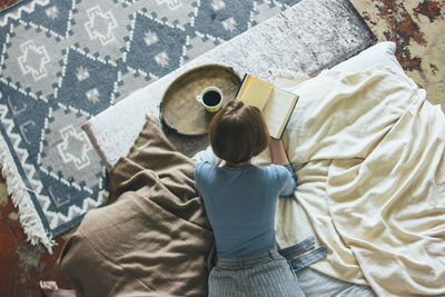 Rear view of boy on bed