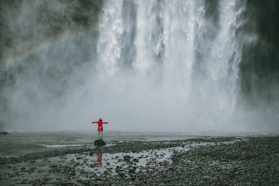 Scenic view of waterfall against sky during winter