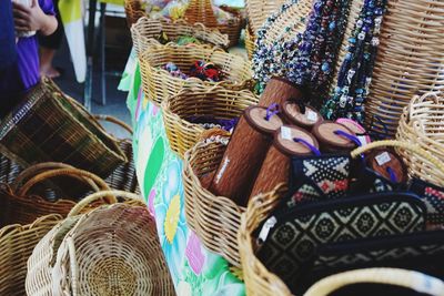 Midsection of woman in basket for sale at market stall