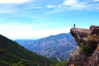 Wide angle of mountain landscape and man on rock formation