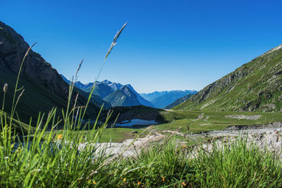 Scenic view of mountains against clear blue sky