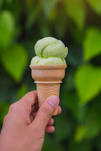 Close-up of hand holding ice cream cone