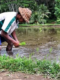 Side view of man working in water