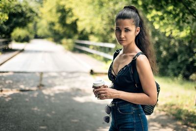 Portrait of young woman standing outdoors