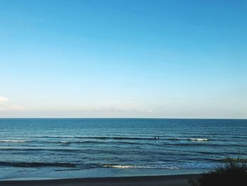 Scenic view of sea against clear blue sky