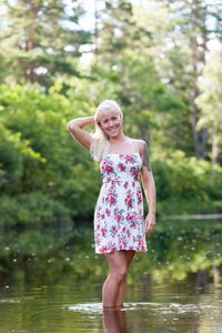 Woman standing in front of lake