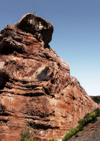 Low angle view of rock formation against clear sky