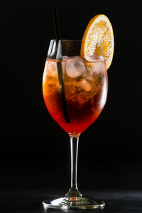 Close-up of beer glass on table against black background