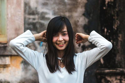 Portrait of smiling young woman standing outdoors